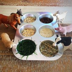 the toy farm animals are eating their food