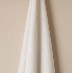 a white towel hanging on the wall