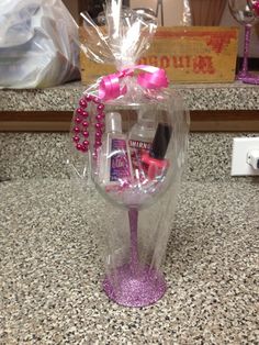 a clear vase filled with pink items on top of a counter