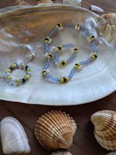 shells and beads are arranged on a tray