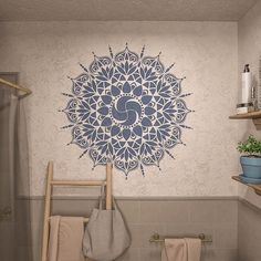 a bathroom with a toilet, sink and shower stall in it that has a decorative wall decal on the wall