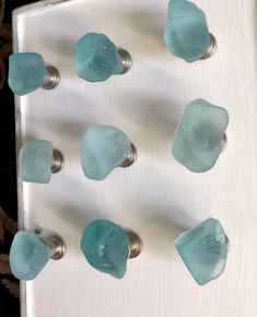 several sea glass knobs on a white door