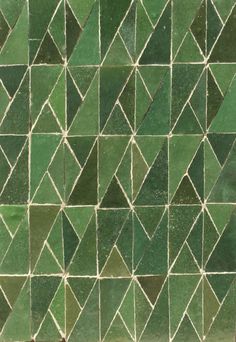 a close up view of a green mosaic tile