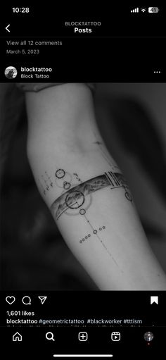 a black and white photo of a person's arm with a tattoo on it