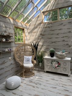 a wicker chair sitting on top of a wooden floor next to a white dresser