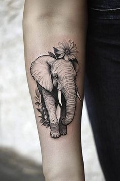 an elephant with flowers on it's head is shown in this black and white tattoo