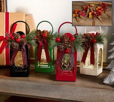 three small christmas gift bags with bows and pine cones on them sitting on a mantle