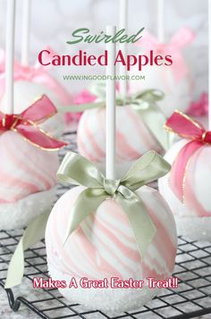 cake pops with pink and white striped candy on a wire rack, tied with ribbon