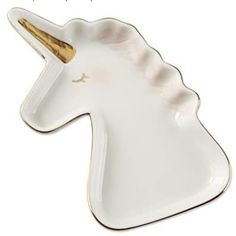 a white unicorn shaped dish with a gold horn