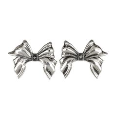 Our Bow Earrings expertly crafted in gleaming silver, emulate the elegance of a real bow. Inspired by the intricate details of the Pregomesh, these earrings feature crisply sculpted elements, capturing the essence of coquettish charm with a touch of boldness. Chic Silver Clip-on Jewelry, Elegant Metal Clip-on Earrings For Evening, Elegant Metal Earrings With Oxidized Finish, Elegant Oxidized Metal Earrings, White Gold Clip-on Earrings For Party, Elegant Silver Earrings For Party, Metal Bow Earrings For Gifts, Elegant Metal Bow Earrings, Chic Metal Jewelry With Bow Detail