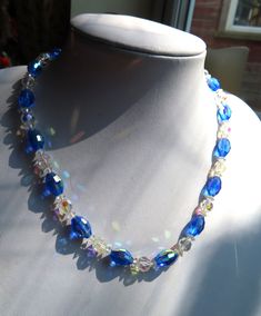 1950's Vintage Blue  & Clear Aurora Borealis Glass Bead Necklace  This necklace is 17" long with a roll over fastener. The main blue beads are nearly 1/2" wide and the clear beads are a bit smaller. This necklace is in a good condition. (09.07.24 D) Vintage Blue Beaded Necklace, Vintage Blue Round Beaded Necklace, Vintage Blue Necklace With Colorful Beads, Elegant Blue Glass Necklaces, Vintage Blue Glass Beaded Necklaces, Clear Beads, 1950 Vintage, Glass Bead Necklace, 1950s Vintage