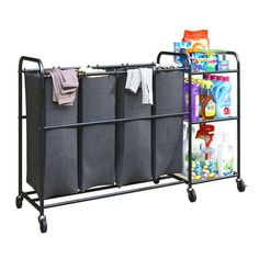 a metal rack with three bins and two laundry bags on wheels, next to a stack of toiletries