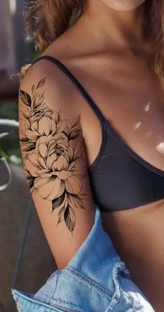 a woman with a flower tattoo on her arm