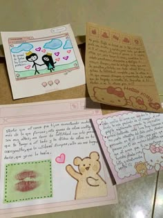 some cards are laying on top of each other with writing and pictures attached to them