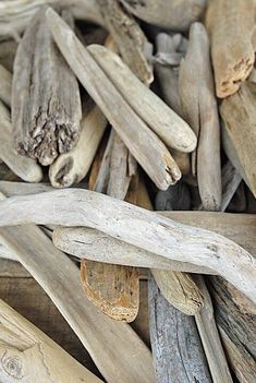 several pieces of driftwood are stacked on top of each other in a pile together