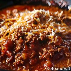 a bowl filled with chili and cheese on top of it