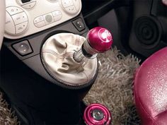 the interior of a car with pink and white accessories