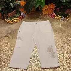 Cache 5 Pocket Cargo Capri Pants. Tan & Gold Embroidery Rear 2 Flap Pockets With Mthe Top. Fold Up Below The Knees With Tab & Button Closure. Fabric: 98% Cotton 2% Spandex Measurements: See Photos 32" Waist 38" Hips 29" Length 20" Inseam 9" Rise Offers Welcomed. L39 This Style Is Also Available In A Separate Listing. (Tan, Size 8). Photo Above. Fitted White Embroidered Bottoms, Fitted Embroidered White Pants, Fitted White Embroidered Pants, White Cotton Capris, White Embroidered Pants For Spring, Spring White Embroidered Pants, Spring Embroidered White Pants, Bling Denim, Capri Cargo Pants