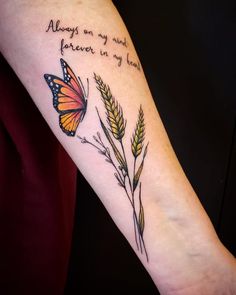 a woman's arm with an orange butterfly and some wheat stalks on it, which reads always are my wings forever in my heart