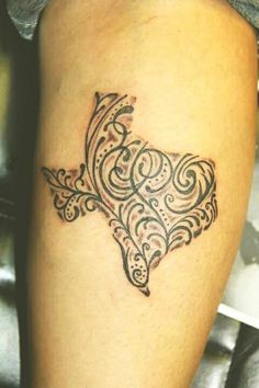 a woman's leg with a tattoo design on the side of her calf area