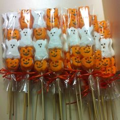 there are many orange and white treats on sticks