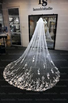 a wedding veil is displayed in front of a store window