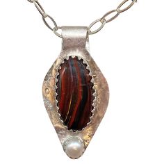 This one of a kind Sterling pendant features a rich brown tiger iron gemstone with a luminous cultured pearl accent. I am reminded of Hot Fudge Sundaes when I see this pendant. the richness of deep brown tiger iron with a pearly whipped cream topping. Plus there are NO CALORIES in this sundae! A textured sterling neck chain is included. Pendant is 2 1/2" high. Tiger Iron Gemstone is 1 1/2" high. neck chain is 20" and can be adjusted down to your preference. Features a sterling silver clasp. Free Brown Pearl Pendant Jewelry Gift, Brown Pearl Pendant Necklace Gift, Brown Pearl Pendant Necklace For Gift, Gift Brown Pearl Pendant Necklace, Brown Pearl Pendant Necklace As Gift, Whipped Cream Topping, Tiger Iron, Brown Tiger, Hot Fudge