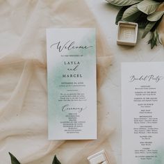 the wedding stationery is laid out on top of each other, including an open ring box