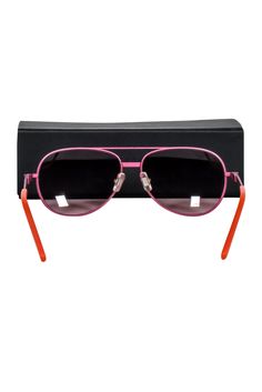 Travel to Barbie's dream vacation with these Fruedenhaus aviator sunglasses. A pink and orange combo will be sure to make all your friends green with envy. Get ready to strut your stuff in style, complete with a beach tote, bikini, and sandals -- and take the sun for a spin! Pink metal frame Dark lens Orange legs Comes with box and cleaning cloth Total length 5" Lens length 2.25" Lens height 1.75" French Girl Chic, Green With Envy, Chic Shop, Barbie Dream, Buy Shoes Online, Dream Vacation, Vacation Style, Beach Tote, French Girl