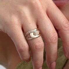 a close up of a person's hand with a ring on it