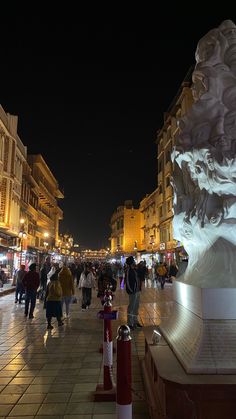 people are walking around in the city at night