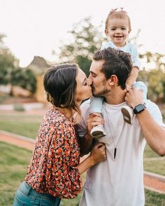 an instagram page with two people kissing and one person holding a baby in the air