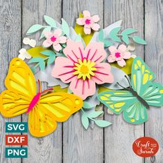 paper flowers and butterflies on a wooden surface