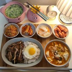 a table topped with bowls filled with different types of food