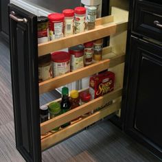 an open cabinet with spices and condiments in it