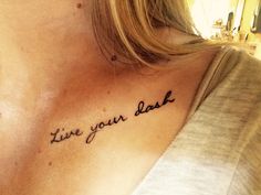 a woman with a tattoo saying live your best on her chest