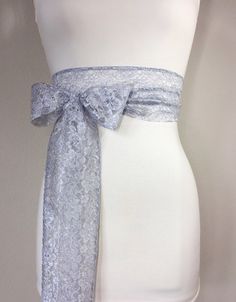 "Silver Lace Sash, Silver Wedding Dress Sash Extra Long Lace Sash, Lace Silver Sash Light Gray Wedding Sash, Gray Lace Sash Satin Swank This Satin Swank® extra long sash in silver floral lace brings a beautiful, yet simple romantic finishing touch to your wedding dress, or adds a hint of nostalgic charm to your special occasion dress or top. At 120 inches in length, this sash will wrap around most waist sizes two times with a generous length remaining to tie in a bow or a simple knot with long-h Light Gray Wedding, Silver Wedding Dress, Lace Sash, Wedding Dress Sash, Gray Wedding, Wedding Sash Belt, Dress Sash, Wedding Sash, Silver Lace