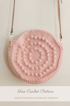 a pink crocheted purse hanging from a hook on a white wall with text overlay that says free crochet pattern