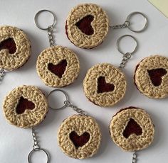 six crocheted keychains with hearts on them are arranged in the shape of circles