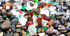 many different colored rocks and pebbles on top of each other with sea glass in them