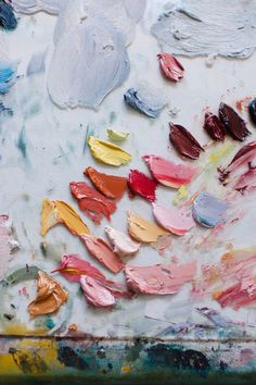 an abstract painting with many different colors and shapes on it's surface, including paintbrushes