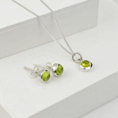 Beautiful Jewellery Set with Peridot gemstone made in sterling silver.  Crystal gemstone, an olive color to bright green, is believed to protect from dark energy. It is also called as an evening emerald because of the way it glows in the night. Peridot is the birthstone of August and an ideal gift for 16th marriage anniversary.  The set consists of birthstone earring studs and pendant necklace.   The necklace comes in 16" and 18" fine curb chain Please avoid in contact with chemicals and use silver cloth to clean. Dark Energy, Marriage Anniversary, August Birthstone Jewelry, Forever Jewelry, August Birthstone, Jewelry Ring Box, Peridot Gemstone, Men's Jewelry Rings, Jewellery Set