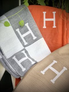 three towels with the letters h and h on them are sitting next to each other