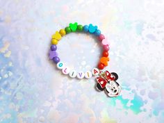 Lovely, bright and colourful bracelet made from 6mm wooden beads and clay Minnies. Kids size is approximately 15cm long and adult size approximately 18cm long. Enamel charm is optional. Multicolor Personalized Novelty Charm Bracelet, Playful Multicolor Personalized Charm Bracelet, Playful Multicolor Beaded Bracelets For Personalized Gift, Colourful Bracelet, Charm Beaded Bracelet, Apple Watch Bands Fashion, Disney Bracelet, Pink Pouch, Girls Personalized Gifts