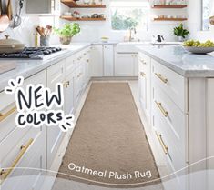 a kitchen with white cabinets and lots of counter space next to a window that says new colors