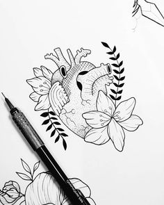 a drawing of a heart with flowers and leaves on the paper next to a pen