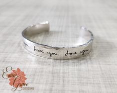 "The handwriting of your loved one will be engraved on this cuff bracelet. This cuff is made of thick sterling silver and is a staple piece you will wear with everything! This bracelet is made by hand, formed, shaped, hammered and polished. The outside has a beautiful hammered texture that creates facets that catch the light. Both the inside and the outside can be engraved with handwriting or add text with a font from our list on one side if you prefer. Bracelet will arrive neatly packaged and ready to wear and enjoy, or give as a gift! {WHAT * YOU * WILL * GET} - - - - - - - - - - - - - - - - - - - - - - - - - Cuff is made by hand, hammered and polished. * (1) sterling silver 8mm x 2mm cuff bracelet - engraving covering up to 3\" on each side * 5-8.5\" in total length depending on the siz Adjustable Sterling Silver Bracelet For Anniversary, Silver Hand Stamped Cuff Bracelet As A Gift, Silver Cuff Bracelet Hand Stamped Gift, Personalized Silver Cuff Bracelet Hand Stamped, Silver Hand Stamped Cuff Bracelet For Personalized Gift, Hand Stamped Sterling Silver Cuff Bangle, Sterling Silver Hand Stamped Cuff Bracelet For Anniversary, Sterling Silver Hand Stamped Cuff Bracelet Gift, Adjustable Sterling Silver Stamped Name Bracelet