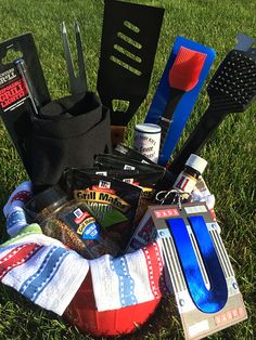 a basket filled with kitchen utensils on top of a grass covered park field