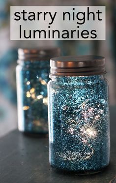 two jars filled with glitter sitting on top of a table