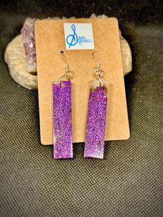 These one-of-a-kind sparkly narrow rectangle panel resin earrings are colored with violet microglitter, sanded smooth, and assembled on silver plated ear wires. Perfect for a night on the town or a day at the office, these earrings will become your go-to when you need a lightweight pop of color. Purple Rectangular Jewelry For Party, Purple Glitter Jewelry For Gifts, Purple Glitter Jewelry Gift, Purple Glitter Earrings For Gift, Diy Resin Projects, Resin Projects, Crystal Prisms, Diy Resin, Resin Earrings